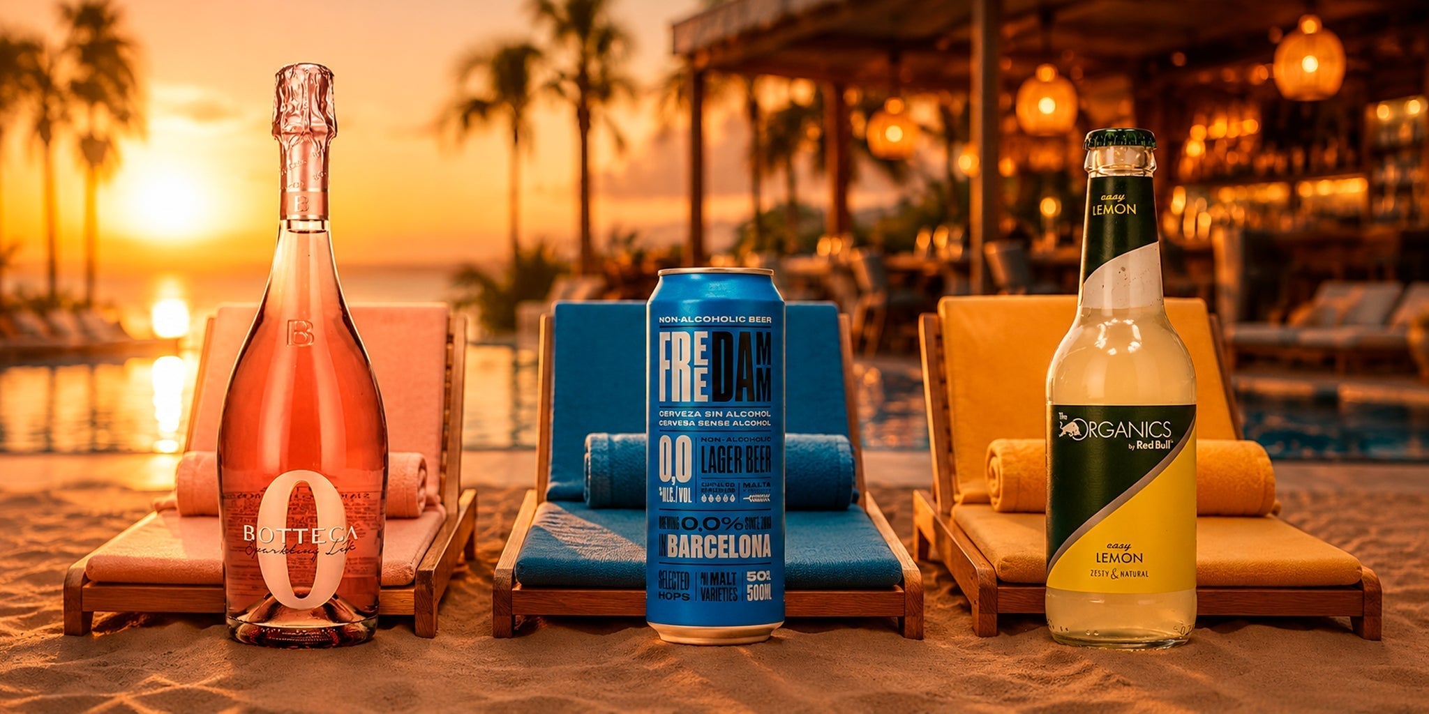 Alcohol-free beach picnic drinks with Bottega Zero, Free Damm 0.0 beer and Red Bull Organics Easy Lemon on sunset beach loungers.