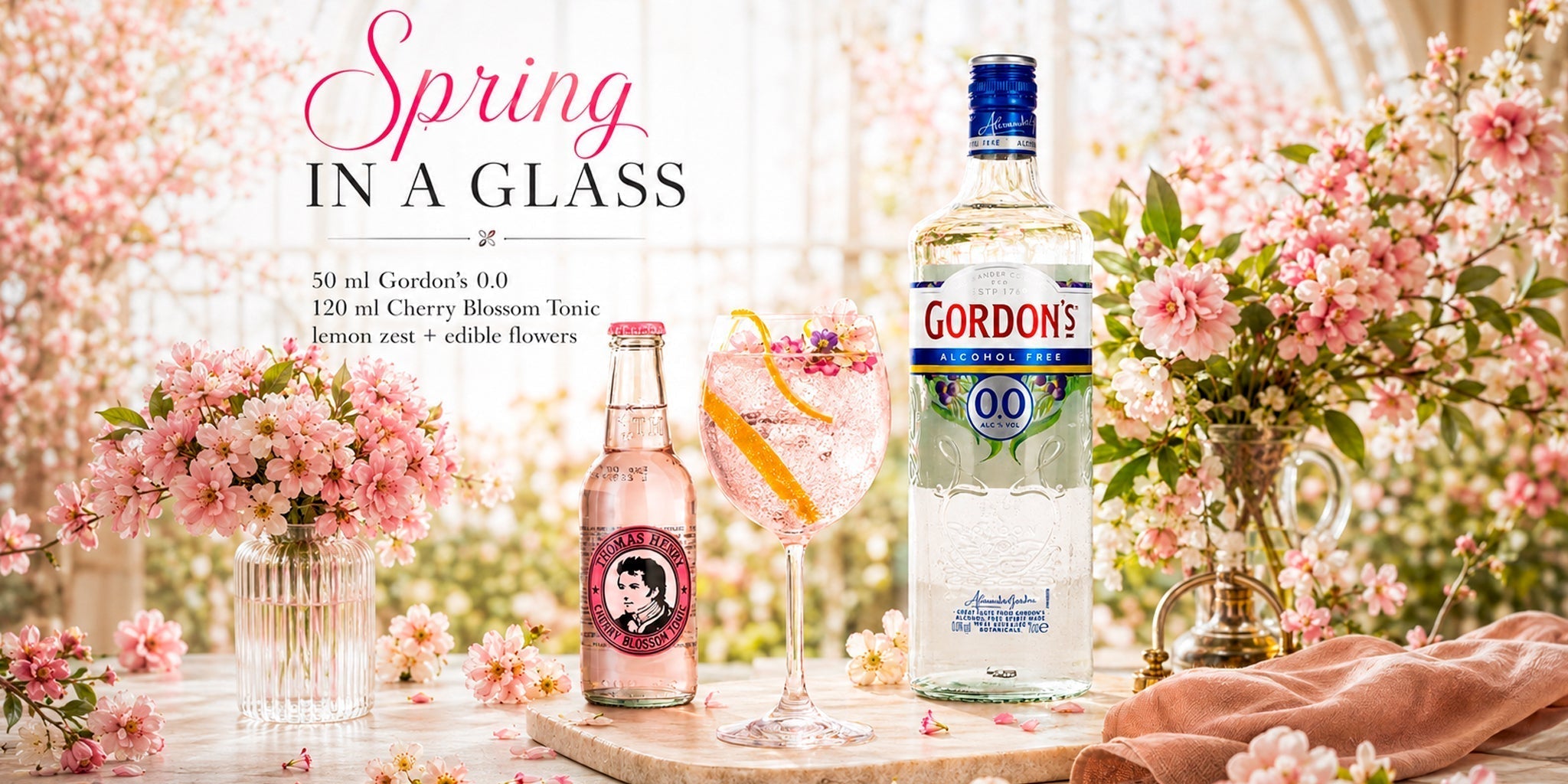 Gordon’s Alcohol Free 0.0 with Thomas Henry Cherry Blossom Tonic and a pink spring cocktail, styled with cherry blossom flowers, lemon zest and soft floral decor.