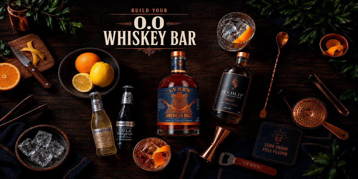 Lyre’s American Malt and Seedlip Malt non-alcoholic spirits styled as a zero-proof whiskey bar with Fever-Tree mixers, citrus, ice and cocktail tools on a dark wooden table.