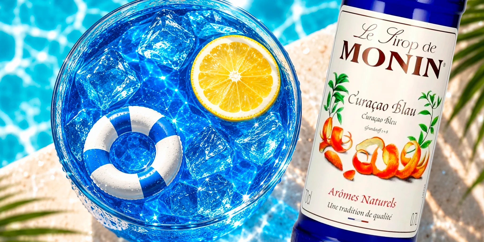 Monin Curacao Blue syrup bottle beside a bright blue iced cocktail with lemon and pool-inspired styling, created as a vibrant summer drink image for mocktails, lemonades and tropical cocktails.